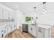 Stylish kitchen with white cabinets, quartz countertops, stainless appliances, and island seating at 10563 Laguna Plains Dr, Riverview, FL 33578