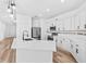 Bright kitchen featuring white cabinets, quartz countertops, and stainless steel appliances at 10563 Laguna Plains Dr, Riverview, FL 33578