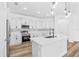 Well-equipped kitchen with white cabinets, stylish backsplash, and stainless steel appliances at 10563 Laguna Plains Dr, Riverview, FL 33578