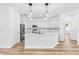 Modern kitchen with white cabinets, stainless steel appliances, and a large island at 10563 Laguna Plains Dr, Riverview, FL 33578