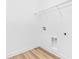 Laundry room with connections and wood-look floors at 10563 Laguna Plains Dr, Riverview, FL 33578