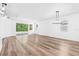 Spacious living area with light wood-look flooring and sliding glass doors at 10563 Laguna Plains Dr, Riverview, FL 33578