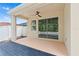 Covered patio featuring a ceiling fan and sliding glass doors to the home's interior at 10563 Laguna Plains Dr, Riverview, FL 33578