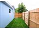 Side yard with a new wood fence and manicured lawn at 1114 Michigan N Dr, Dunedin, FL 34698
