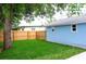 Manicured backyard featuring a wood fence and mature tree at 1114 Michigan N Dr, Dunedin, FL 34698