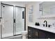 Beautiful bathroom features marble-look shower, black fixtures, and stylish vanity with gold hardware at 1114 Michigan N Dr, Dunedin, FL 34698