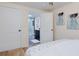 Comfortable bedroom leads to a newly renovated bathroom with elegant fixtures and a modern design, creating a serene retreat at 1114 Michigan N Dr, Dunedin, FL 34698