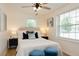 Charming bedroom with bright windows, hardwood floors, and stylish blue accents at 1114 Michigan N Dr, Dunedin, FL 34698