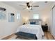 Cozy bedroom featuring a queen-size bed, a decorative bench, and modern decor with natural light from two windows at 1114 Michigan N Dr, Dunedin, FL 34698