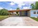 Open carport showing ample parking space with a durable concrete slab, attached to the home at 1114 Michigan N Dr, Dunedin, FL 34698