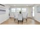 Bright dining space featuring a round table with gray upholstered chairs and large windows offering plenty of natural light at 1114 Michigan N Dr, Dunedin, FL 34698