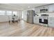 Open-concept kitchen and dining area with stainless steel appliances, gray cabinetry, and a dining table set for four at 1114 Michigan N Dr, Dunedin, FL 34698