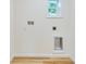 A well-lit laundry room with utility hookups and wood-look flooring at 1114 Michigan N Dr, Dunedin, FL 34698
