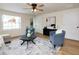 Comfortable living room featuring stylish furnishings, a ceiling fan, and sleek hardwood floors at 1114 Michigan N Dr, Dunedin, FL 34698