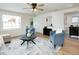 Living room showcasing an open floor plan, modern decor, and connection to the updated bathroom at 1114 Michigan N Dr, Dunedin, FL 34698