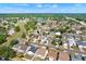 Expansive aerial view of a vibrant residential community featuring lush greenery, a scenic pond, and well-maintained homes at 11307 Calgary Cir, Tampa, FL 33624