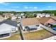 Aerial view of the backyard featuring a screen-in porch, a brick-paved patio, and a fenced in lawn at 11307 Calgary Cir, Tampa, FL 33624