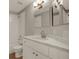 Bathroom featuring a vanity with modern fixtures, a large mirror and a shower/tub combo at 11307 Calgary Cir, Tampa, FL 33624