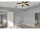 Spacious bedroom with tile flooring, ceiling fan, and neutral paint at 11307 Calgary Cir, Tampa, FL 33624