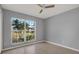 Bedroom with tile flooring, gray walls, and a bright window featuring neighborhood views at 11307 Calgary Cir, Tampa, FL 33624