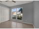 Bedroom featuring tile floors, a large window with neighborhood views, closet and gray walls at 11307 Calgary Cir, Tampa, FL 33624