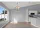 Bright dining area with neutral walls, tile floors, natural light and a chandelier fixture at 11307 Calgary Cir, Tampa, FL 33624