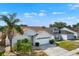 Charming single-story home with a well-manicured lawn, a two-car garage, and a beautiful brick-paved walkway at 11307 Calgary Cir, Tampa, FL 33624
