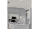 Bright kitchen features stainless appliances, gray walls, white cabinets and recessed lighting at 11307 Calgary Cir, Tampa, FL 33624