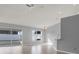 Bright living room featuring sliding glass doors, tile flooring, and neutral gray walls at 11307 Calgary Cir, Tampa, FL 33624