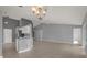 Open-concept living room and kitchen with tiled floor, neutral walls, and vaulted ceilings at 11307 Calgary Cir, Tampa, FL 33624