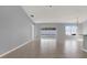 Open and airy living room featuring tile floors, neutral gray walls, and sliding glass door to patio at 11307 Calgary Cir, Tampa, FL 33624