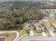 A high-angle view shows a home with a pool and a nearby wooded area, as well as its proximity to neighbors at 12607 Flatwood Creek Dr, Gibsonton, FL 33534
