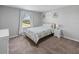 This cozy bedroom features ample natural light, neutral walls, and a comfortable bed next to white nightstand at 12607 Flatwood Creek Dr, Gibsonton, FL 33534
