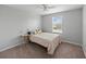 Cozy bedroom featuring a soft carpet, ceiling fan, and a window providing natural light at 12607 Flatwood Creek Dr, Gibsonton, FL 33534