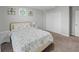 A comfy bedroom features neutral walls, a bed with floral bedding, and art pieces adorning the wall at 12607 Flatwood Creek Dr, Gibsonton, FL 33534