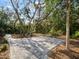 Spacious driveway featuring paver stones and mature trees creating an inviting entrance at 12607 Flatwood Creek Dr, Gibsonton, FL 33534