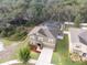 Aerial view of a two-story home with a well-manicured lawn and screened-in pool in a neighborhood at 12607 Flatwood Creek Dr, Gibsonton, FL 33534