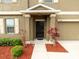 A close-up of the home's front door, showcasing a welcoming entrance and tidy landscaping at 12607 Flatwood Creek Dr, Gibsonton, FL 33534