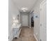 Bright hallway with tile flooring, featuring a stylish console table and decor at 12607 Flatwood Creek Dr, Gibsonton, FL 33534