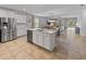 Bright kitchen featuring stainless steel appliances, large island and open layout to dining and living room at 12607 Flatwood Creek Dr, Gibsonton, FL 33534