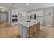 Spacious kitchen featuring a central island, stainless steel appliances, and bright lighting at 12607 Flatwood Creek Dr, Gibsonton, FL 33534