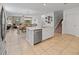 Bright kitchen with large island featuring stainless steel dishwasher and opening to dining and living area at 12607 Flatwood Creek Dr, Gibsonton, FL 33534