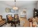 Cozy living room featuring elegant seating, decor, and seamless transition to the hallway at 12607 Flatwood Creek Dr, Gibsonton, FL 33534