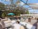 Inviting screened-in pool area with patio seating, perfect for outdoor relaxation and entertainment at 12607 Flatwood Creek Dr, Gibsonton, FL 33534