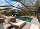 Serene screened-in pool with comfortable lounge chairs and lush surroundings, ideal for leisurely days at 12607 Flatwood Creek Dr, Gibsonton, FL 33534