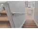 View of carpeted stairs leading to a kitchen with marble countertops and stainless steel appliances at 12607 Flatwood Creek Dr, Gibsonton, FL 33534