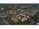 Aerial view of community featuring mature trees, pool, and manicured landscaping at 12900 Vonn Rd # F101, Largo, FL 33774