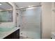 Bathroom featuring granite countertop, a glass bowl sink, an updated shower, and chrome hardware at 12900 Vonn Rd # F101, Largo, FL 33774