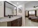 Stylish bathroom with updated granite vanity, framed mirror, and convenient access to the bedroom at 12900 Vonn Rd # F101, Largo, FL 33774