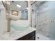 Bathroom showcasing a glass bowl sink, chrome fixtures, and updated tile shower with niche at 12900 Vonn Rd # F101, Largo, FL 33774